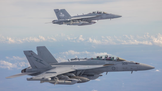 Two Royal Australian Air Force EA-18G Growlers fly alongside a KC-30A Multi-Role Tanker Transport aircraft over the Northern Territory during Exercise Diamond Storm 2022.