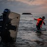 French police enter the water at Gravelines to try to stop migrants boarding small boats in June.