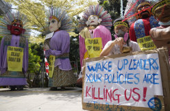 Environmental activists display posters as performers dance in traditional giant effigies called “ondel-ondel” during a climate strike rally in Jakarta on Sunday.