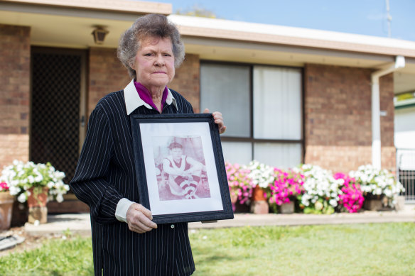 Bev Roberts at her Queensland home with a photo of her brother, Russell Martin.
