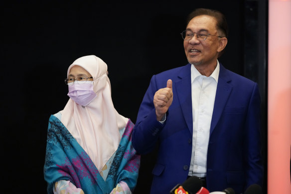 Malaysian opposition leader Anwar Ibrahim, right, and his wife, MP and former deputy PM Wan Azizah poses for a photo after meeting the King in Kuala Lumpur, Malaysia, on Tuesday.