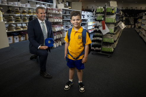 Lachlan Tratt, 6, in his Kew East Primary School uniform, pictured with proprietor Francis Stewart at the Bob Stewart store in Kew.
