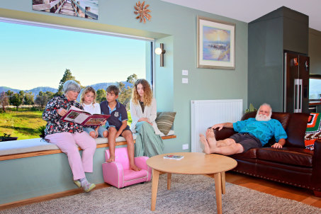 Dave and Barbara Rugendyke and family members in their new home in Cobargo.