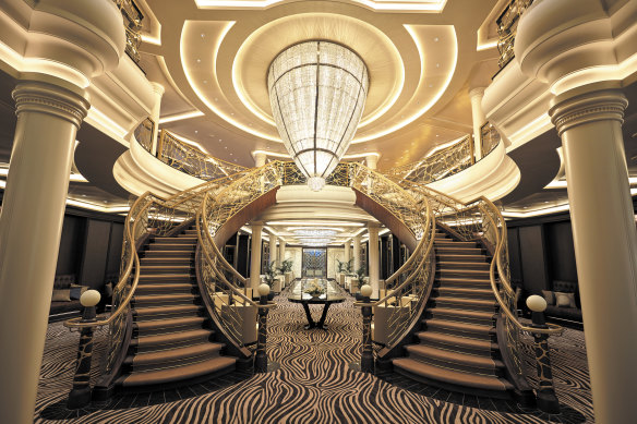 The atrium features a gigantic crystal chandelier, flanked by two sweeping staircases