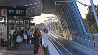 Passengers await one of the first sky rail trains on Thursday morning.