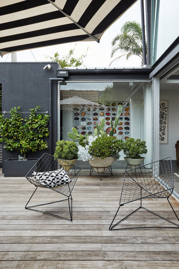 The large, vintage, conical pots were found at garage sales and at Mark Denver antiques, and the chairs were a roadside find that Lynda had powder-coated.