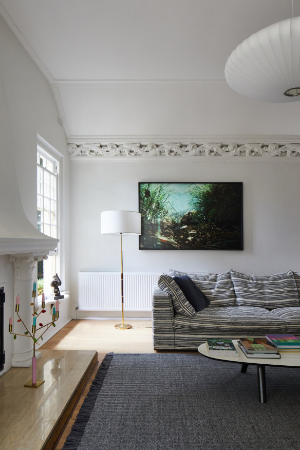 The home has a mix of contemporary pieces like this Maxalto sofa from Space and a vintage lamp from Angelucci. The Powerful Owl photo is by Matthew Stanton.