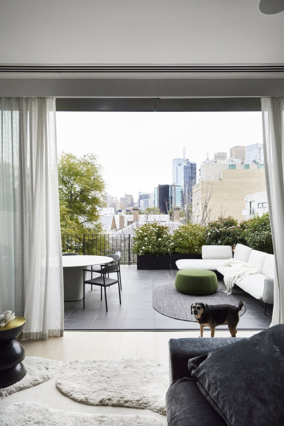 The lounge room on the second level leads to a terrace with a view to Melbourne’s city centre. The outdoor lounge is from 
Cosh Living.