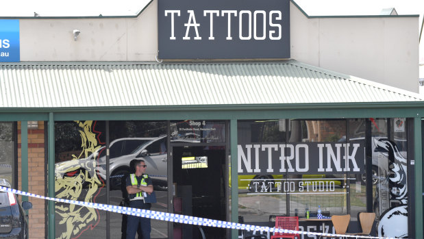 A police officer guards the Nitro Ink tattoo parlour.