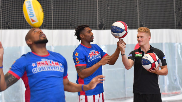 Adam Treloar with Harlem Globetrotters Corey "Thunder" Law and Scott "Scooter" Christensen at Collingwood on Tuesday.