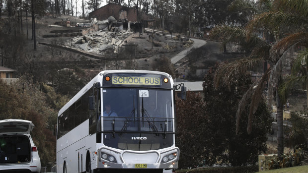 A bus ferrying Tathra residents takes them on a tour of the fire-affected town.