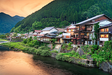 Gujo Hachiman, Japan hot springs town at dusk over the Yoshida River.