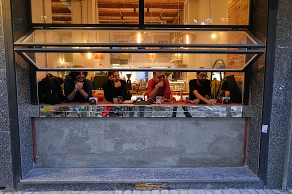 Iranian men sit at a cafe in downtown Tehran on Tuesday.