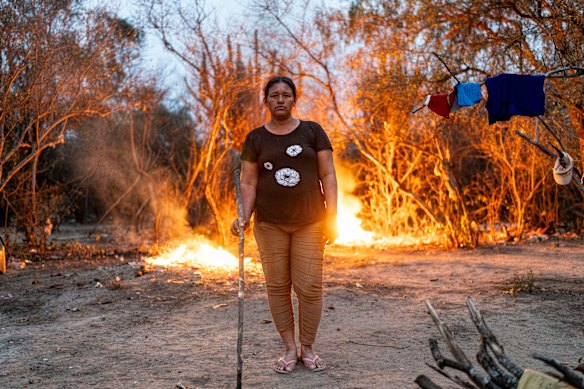 Manjui Indigenous Raquel Achucarro poses for a photo as she tends to a backyard burning in the Abisai community in Mariscal Estigarribia, in the western region of Paraguay known as the Paraguayan Chaco.