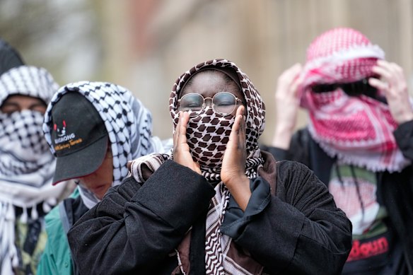Demonstrators chant slogans outside the Columbia University campus in New York. The protesters were calling for the school to divest from corporations they claim profit from the war in the Middle East.