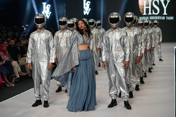 Models present creations by designer Hassan Sheheryar Yasin during Laam Fashion Week in Lahore, Pakistan