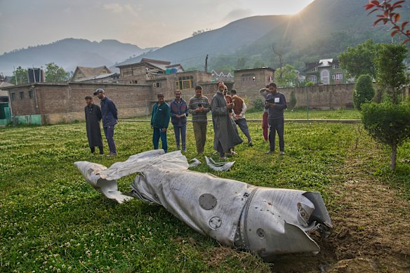 Unidentified aircraft debris lies on the ground near a mosque in Indian-controlled Kashmir.