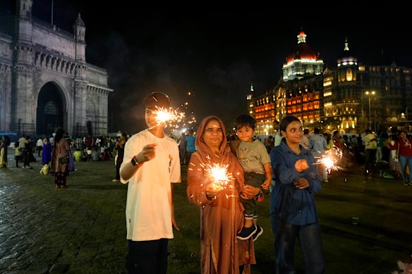 People light fireworks as they celebrate New Year’s Eve near the iconic Gate way of India, in Mumbai.