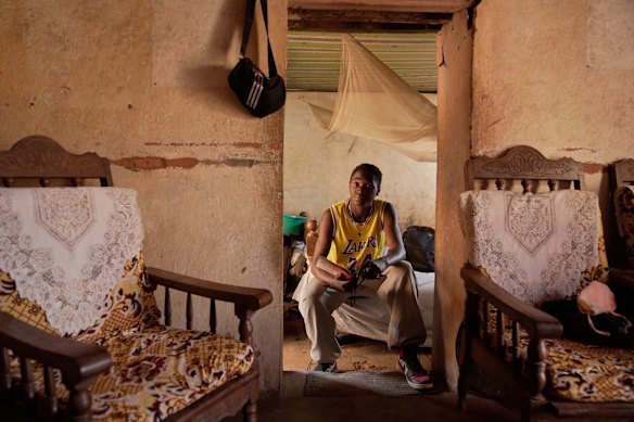 Donah Falia, a 20-year-old student pursuing an accounting course at ABC College, sits inside his aunt’s house in Anosimahavelona informal settlement in Antananarivo, Madagascar.