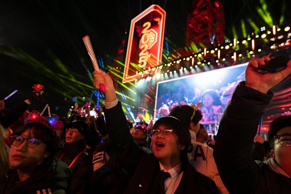 Revellers ring in the new year during a count-down event held in Beijing.