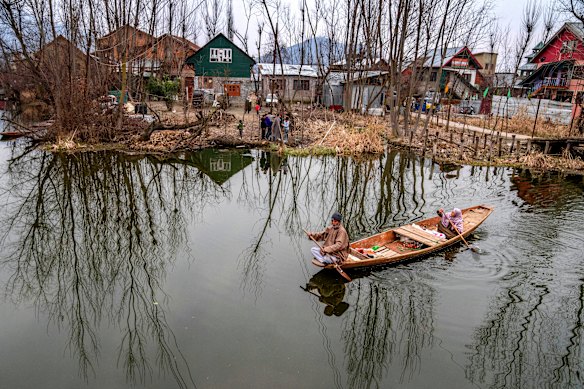 A couple on their way home after the day’s work row a shikara, or traditional boat, in the interiors of the Dal Lake in Srinagar, Indian controlled Kashmir.