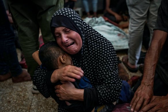 aten Mreish mourns her son who was killed in the Israeli bombardment of the Gaza Strip at a hospital morgue in Deir al-Balah.