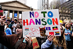 Students hold signs protesting Pauline Hanson in Melbourne.
