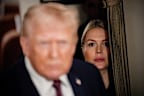 FILE - White House press secretary Karoline Leavitt watches as President Donald Trump speak to reporters while in flight on Air Force One to Joint Base Andrews, Md., Jan. 11, 2026. (AP Photo/Julia Demaree Nikhinson, File)