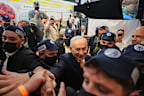 Israeli Prime Minister Benjamin Netanyahu greets supporters at a Tel Aviv market.