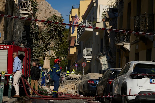 Firefighters work at the scene following a powerful blast that caused a building to collapse and injured at least two people in Athens’ Plaka district, Friday, Sept. 25, 2026.