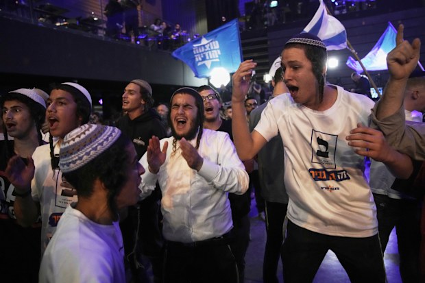 Supporters of Itamar Ben Gvir’s Otzma Yehudit party celebrate after the release of the first exit poll results.