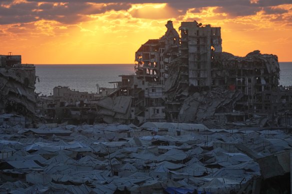 Tents sheltering displaced Palestinians are seen amid war-damaged buildings in Gaza City, Wednesday, Sept. 23, 2026.