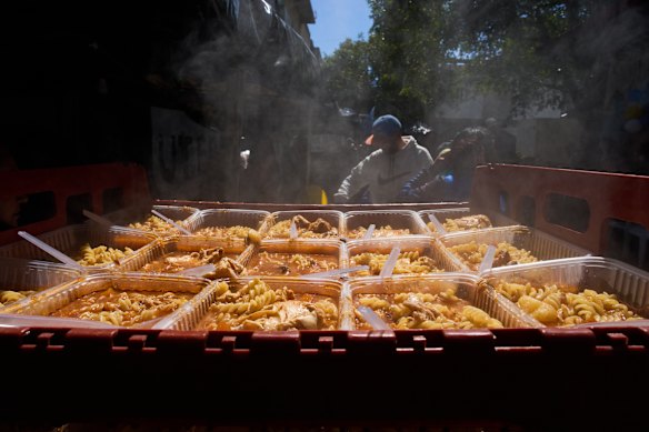 Free meals sit in a crate for distribution by the Union of Workers of the Popular Economy volunteers in Buenos Aires, Argentina, Wednesday, Sept. 23, 2026.