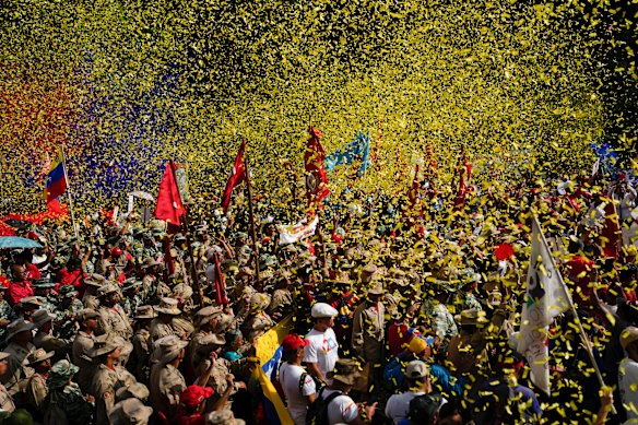 Confetti showers Bolivarian Militia members and government supporters at a march commemorating a 2004 speech by late President Hugo Chavez that is considered a key anti-imperialist moment by his supporters in the history of Chavez’s Bolivarian Revolution in Caracas.
