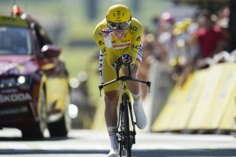 Sloveniaâ€™s Tadej Pogacar, wearing the overall leaderâ€™s yellow jersey, celebrates as he crosses the finish line of the twentieth stage of the Tour de France.
