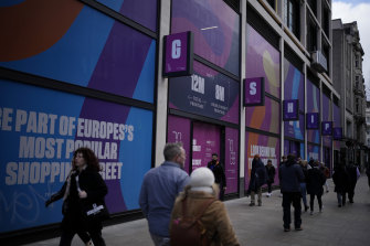 People walk past a closed down shop unit on Oxford Street, in London, where energy prices are spiraling.