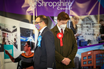 Conservative Party candidate Neil Shastri-Hurst (left) and Ben Wood, of the Labour Party, listen to North Shropshire by-election winner Helen Morgan of the Liberal Democrats, make her acceptance speech on Friday.