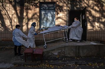 Medical staff members transport the body of a patient who died of COVID-19 in Rivne, Ukraine last month.