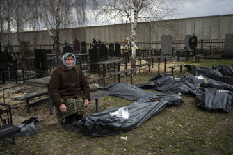 Nadiya Trubchaninova, 70, sits next to a plastic bag that contains the body of her son Vadym, who was killed by Russian soldiers in Bucha on March 30.