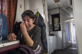A woman weeps on the evacuation train in Pokrovsk.