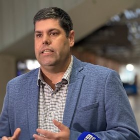 Transport Minister Brent Mickelberg speaks at Central Station in Brisbane on Friday as QR struck a pay deal with rail workers.