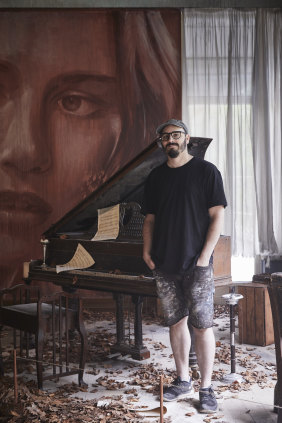 Melbourne street artist Rone inside his exhibition at Burnham Beeches.