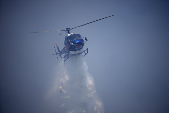 A helicopter drops water on a forest fire near Le Luc, southern France, on Thursday.