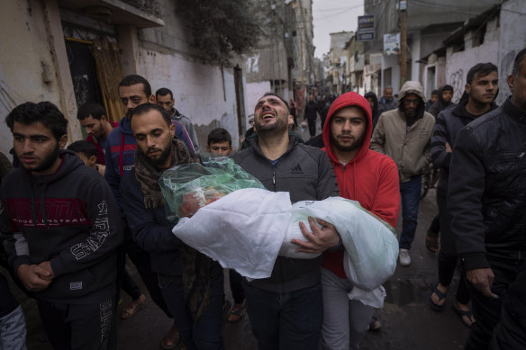 Mohammad Shouman carries the body of his daughter, Masa, who was killed in an Israeli bombardment of the Gaza Strip, at her funeral in Rafah on Tuesday. 