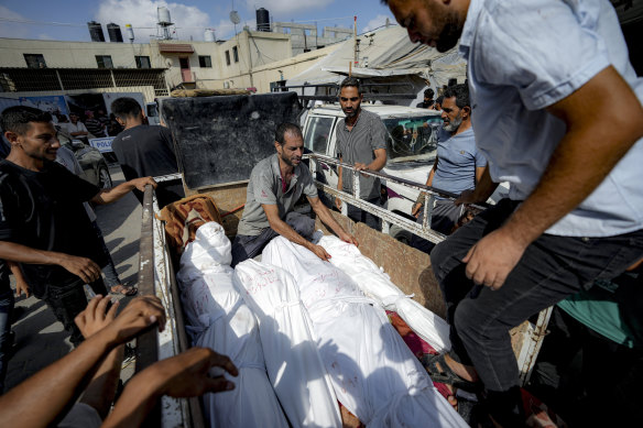 Palestinians gather near the bodies of relatives killed in the Israeli bombardment of Deir al-Balah.