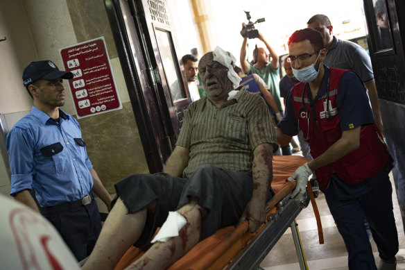 A wounded Palestinian man is wheeled into the Nasser Medical Complex, following Israeli airstrikes on the town of Khan Younis in the southern Gaza Strip.