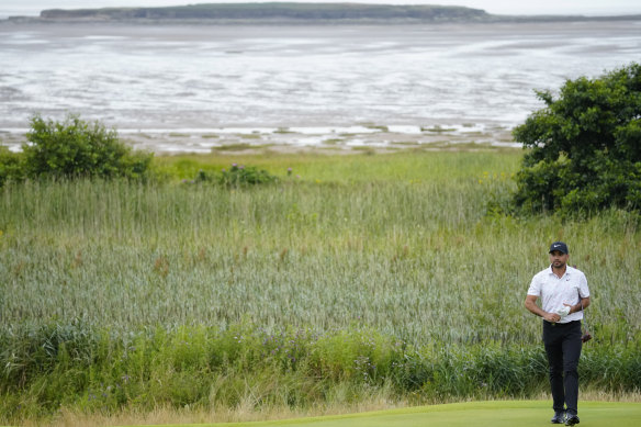 Jason Day looks at his putt on the 13th hole.