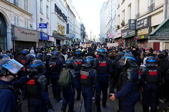 Police officers manage the huge crowds.