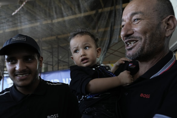 Qaid Farhan Alkadi, 52, right, who was held hostage by Hamas militants in the Gaza Strip, with his son and his brother Ismail al-Qadi, left, at the entrance of the ‏Soroka Medical Centre in Beersheba, Israel.