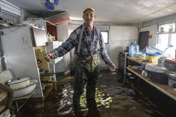 Mykola Gurzhiy, 74, a local fisherman, in the kitchen of his flooded house on the island of Kakhovka, on the Dnipro river near Lysohirka.